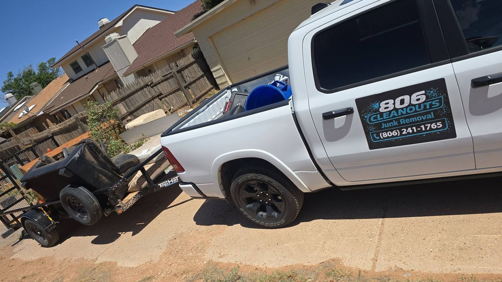 White 806 Cleanouts pickup truck with the company logo and (806) 241-1765 on the door, with a utility trailer hitched behind it in a driveway